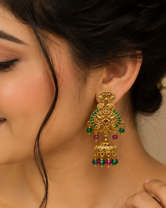 Gold ruby emerald round filigree arabesque chandelier stud with CZ centre dome jhumka and ruby emerald crystal bead drops on cream display