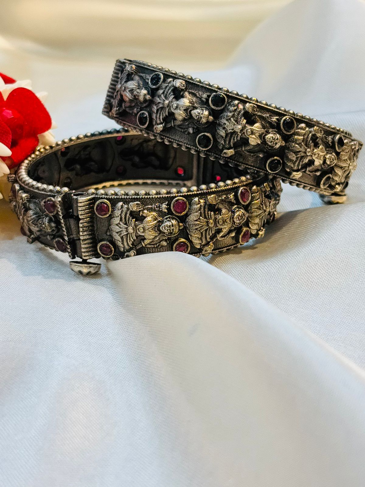 Decorative metal belt with intricate designs on a white surface